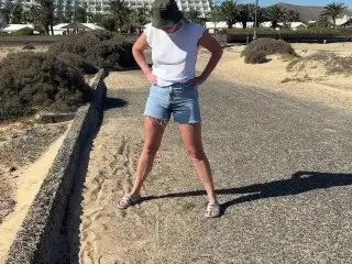 Girl Pisses in Jeans Shorts at the Street in Public