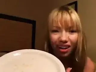 Beautiful Asian girl spits phlegm onto a plate and shows us