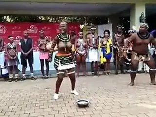 Busty African girl and fat guy doing some sort of show