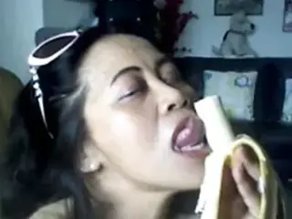 THAI MATURE LADY SHOWING HER BIG BOOBS AND SUCKING BANANA