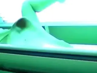 Sexy girl caught masturbating in the solarium