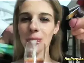cute teen drinks a glass of wine mixed with mens cum