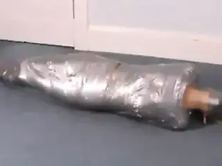 Blonde girl wrapped in duct tape struggles