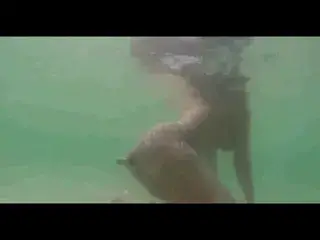 Girl swiming with bottle in ass