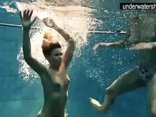 Two sexy amateurs showing their bodies off under water