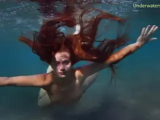 Enjoying a redhead underwater lesbian sex