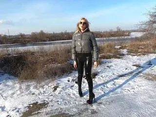 Blonde MILF walking in shiny leggings and puffer jacket