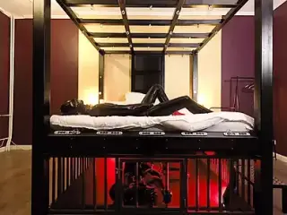 Rubber Nights: the Rubber Slave Rests Tight in a Cage Under the Bed