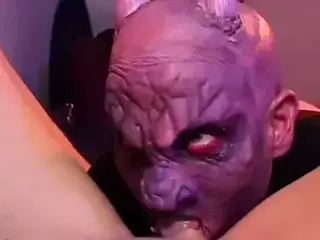 Masked man is on his knees eating out her pussy